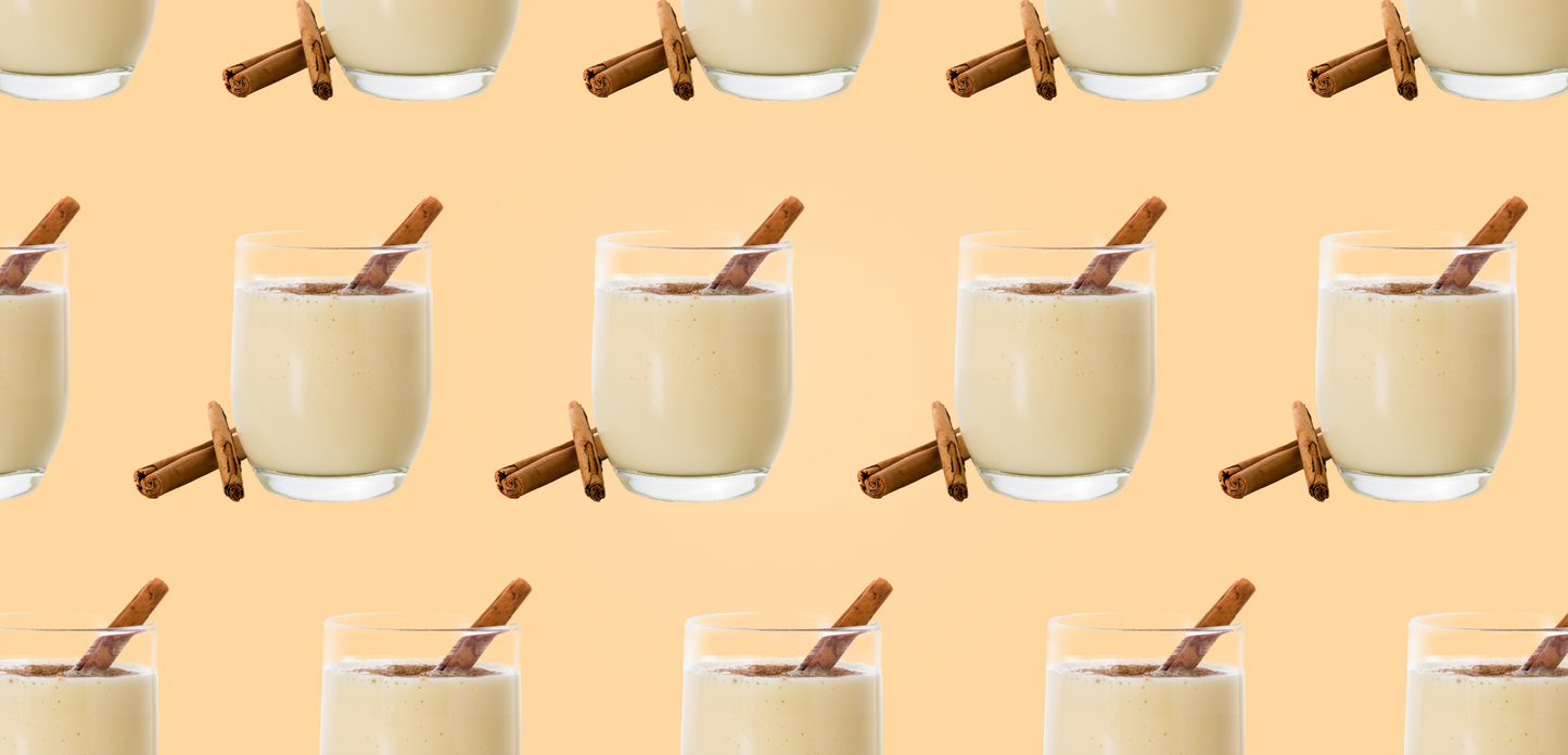 Eggnog Protein Powder. Glasses of egg nog with cinnamon sticks.